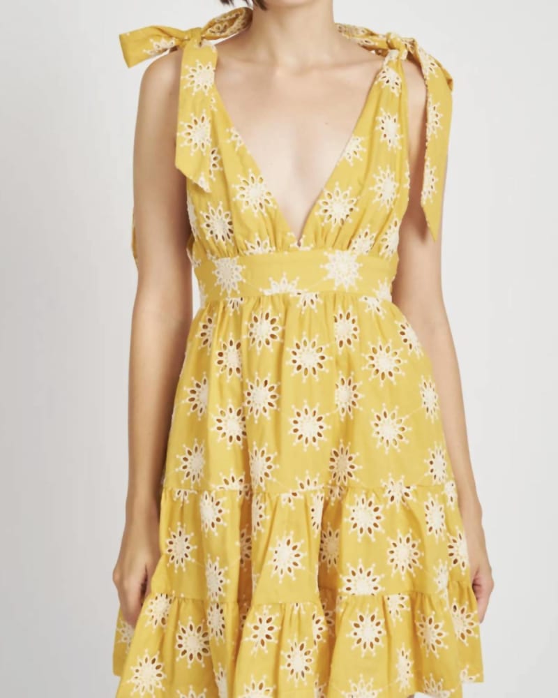 Side of a model wearing a size L Embroidered Tiered Mini Dress in Yellow in Yellow by En Saison. | dia_product_style_image_id:335184